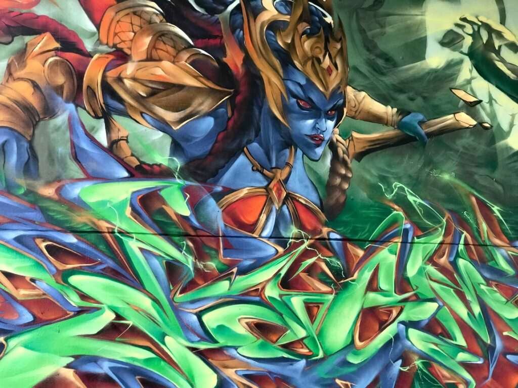 Graffiti de guerrera azul en un bosque con letras wildstyle. Festival Meeting Of Styles en Wiesbaden, Alemania