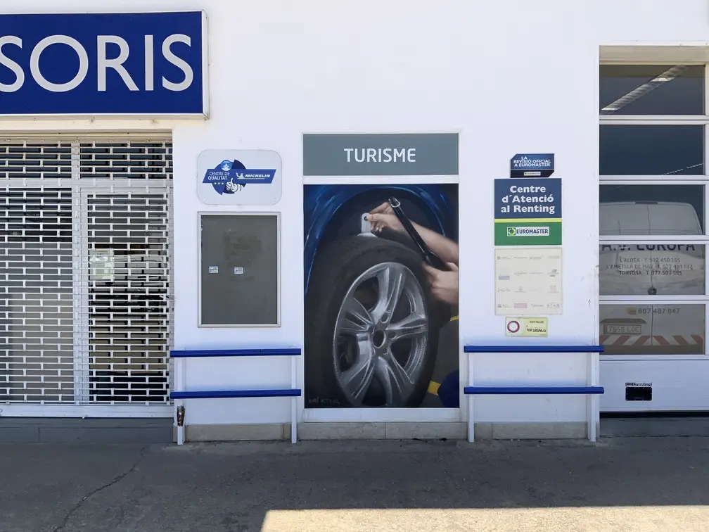 Graffiti profesional con imágenes de coches en taller Euromaster Tortosa
