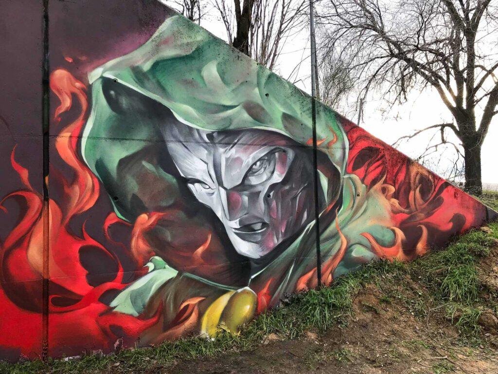 Mural de Doctor Doom, villano de Marvel, con capucha verde y fondo de fuego