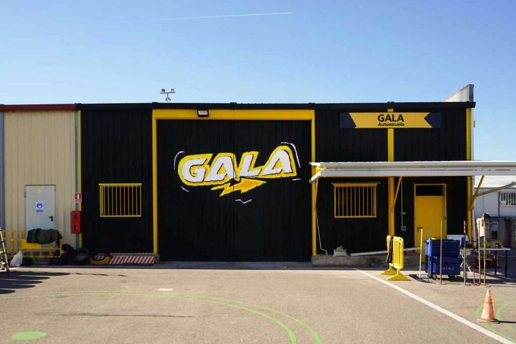 Fachada con graffiti de Autoescuela Gala en pistas de Sanchinarro