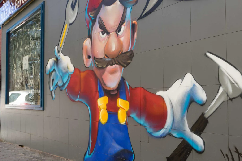 Mural para fontanería con personaje tipo Mario y herramientas, arte urbano comercial