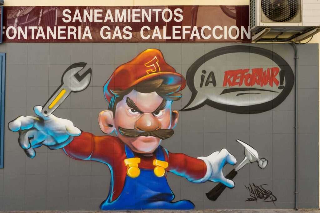 Mural para fontanería con personaje tipo Mario y herramientas, arte urbano comercial