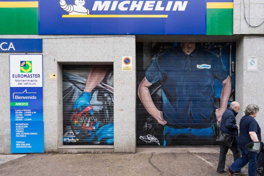 Mural mecánico realista en taller Euromaster Usera con motor y ruedas