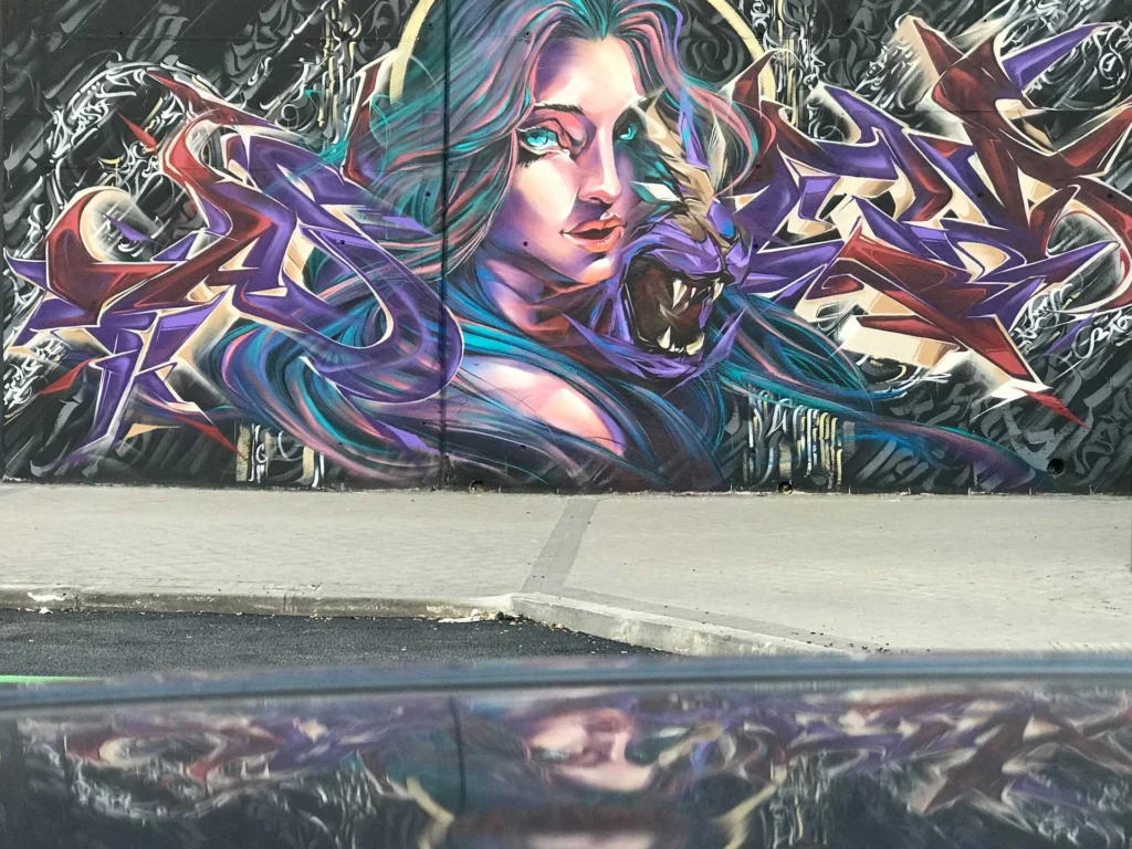 Mural de graffiti con mujer y trazos salvajes en el Colegio Gregorio Marañón