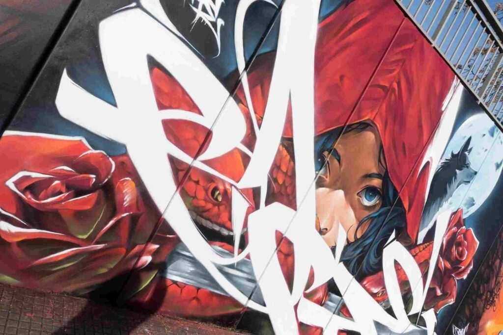 Mural exterior de La Caputxeta Vermella realizado por Asem Navarro para Enamurart Graffiti Jam