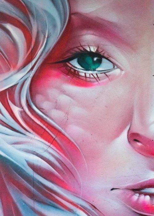 Mural retrato femenino hiperrealista en tonos rosados y blancos