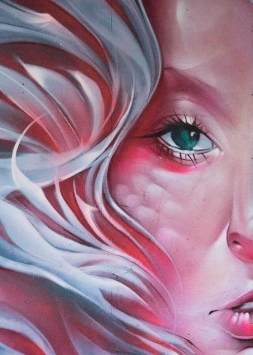 Mural retrato femenino hiperrealista en tonos rosados y blancos