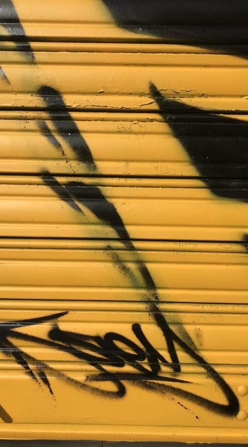 Graffiti BMW negro en persiana de Gala en Paseo de Extremadura