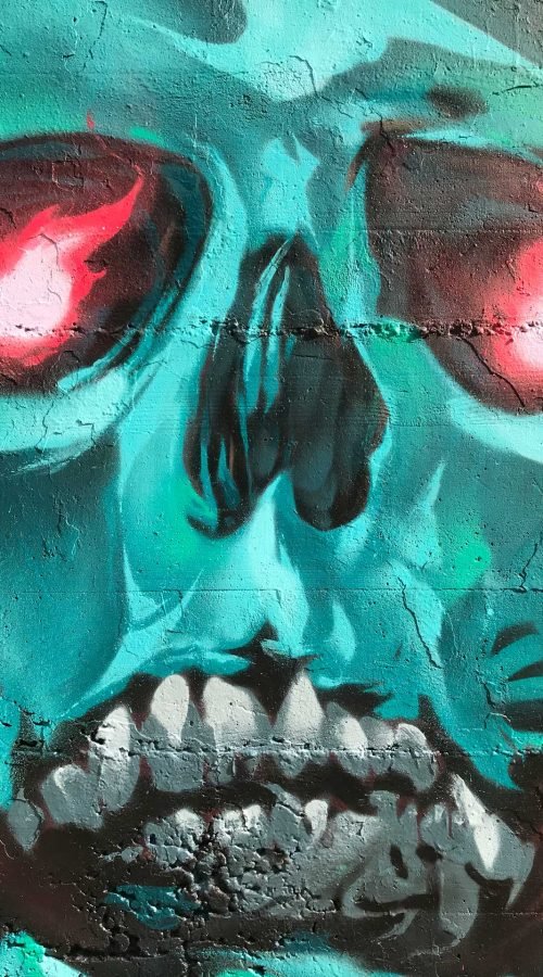 Graffiti de calavera azul con capucha y ojos rojos brillantes