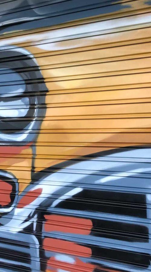 Coche clásico pintado en cierre de Autoescuela Gala Arturo Soria, graffiti realista