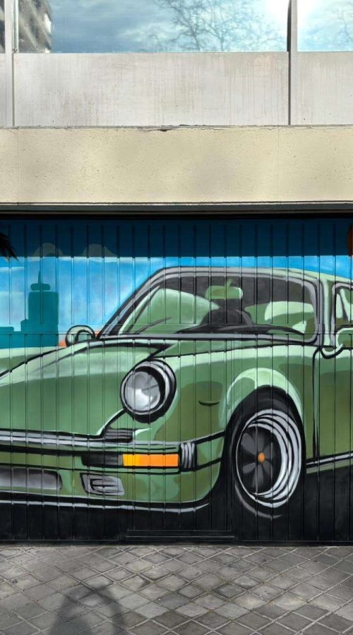 Graffiti mural de coche clásico verde en cierre de garaje para comunidad de vecinos