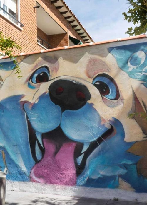 Mural con perros felices en fachada de clínica veterinaria en Toledo