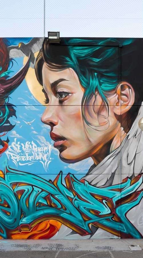 Retrato mural en fachada de edificio público en Godella, arte urbano profesional