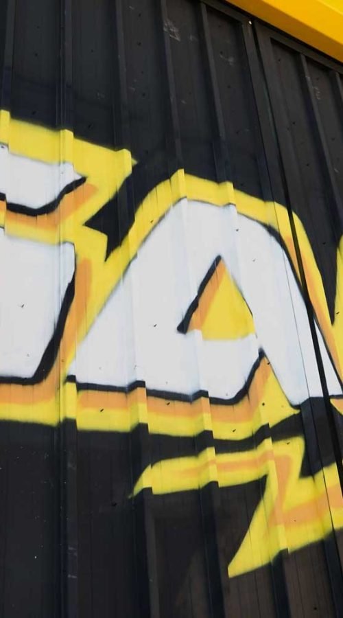 Fachada con graffiti de Autoescuela Gala en pistas de Sanchinarro