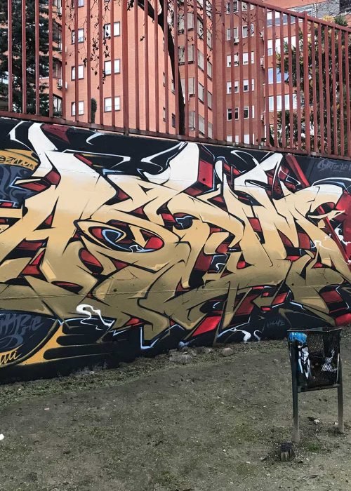 Graffiti de ninja samurái con armadura dorada y fondo rojo urbano