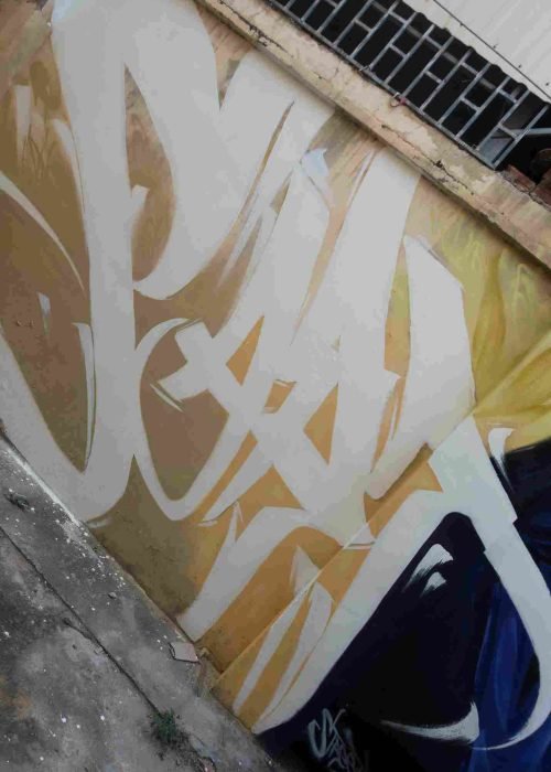 Mural graffiti en fachada de Camboya, retrato femenino con gorra para S’art Urban Art Festival.