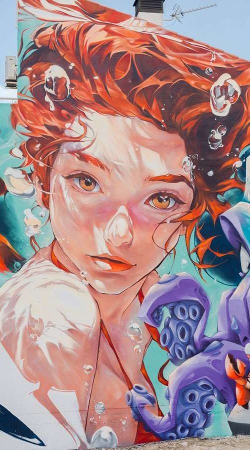 Graffiti de La Sirenita en fachada pública de L’Ametlla del Mar , Cataluña